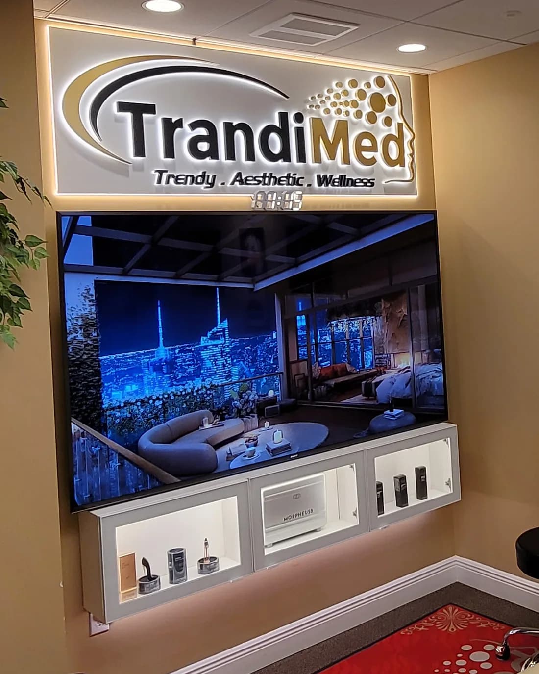 The lit Trandi Med sign over a wall display at the clinic