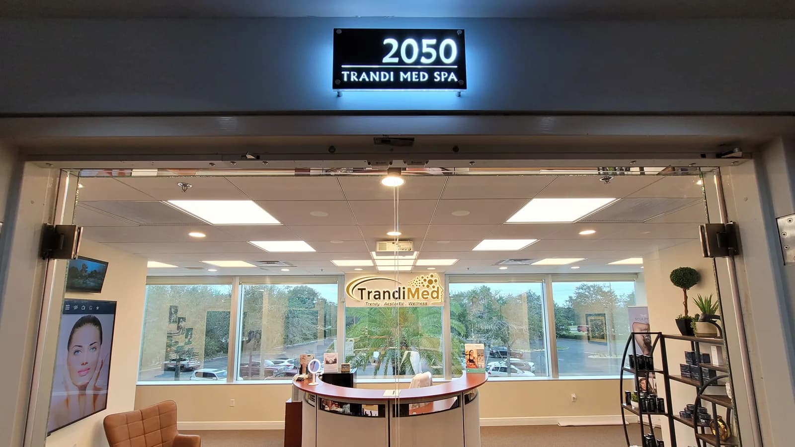 Glass entrance of Suite 2050 and the curved reception desk inside