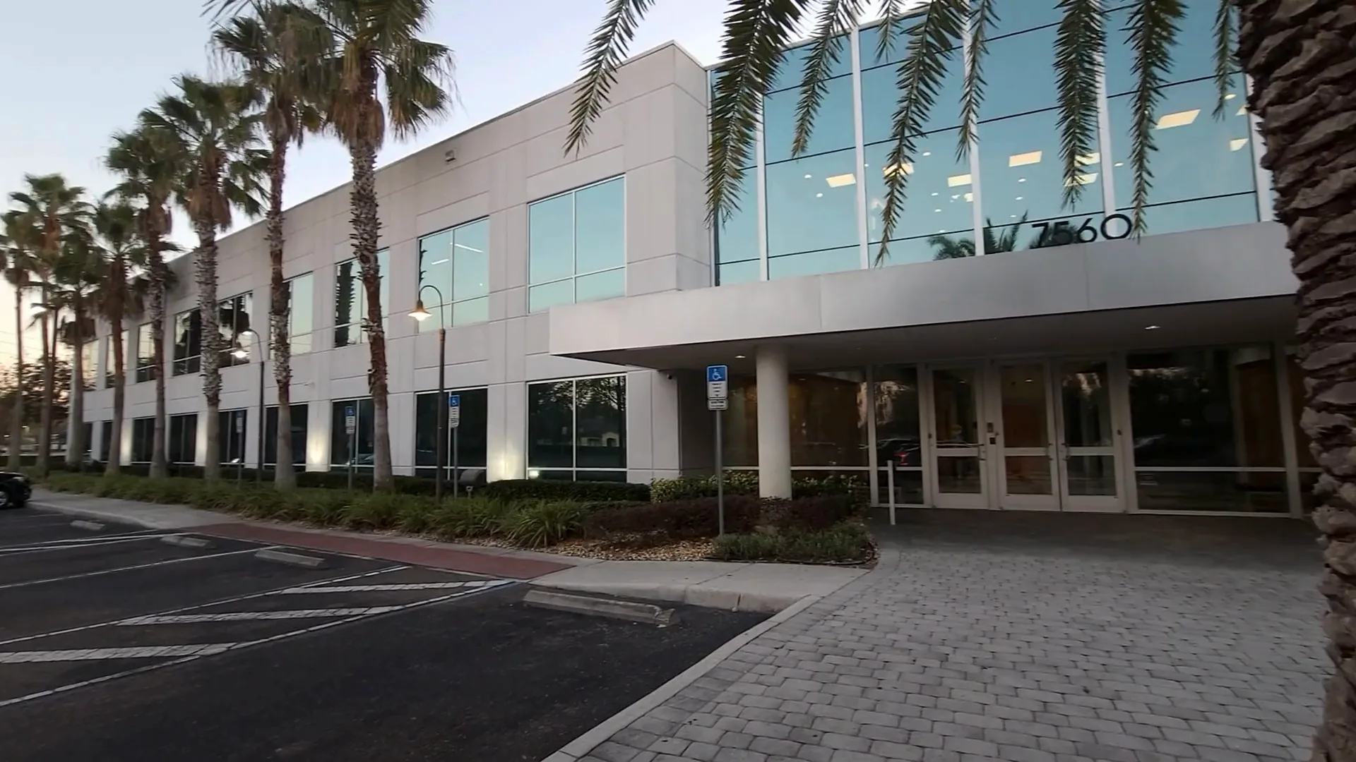Surface parking lot and the paved path to the covered main entrance